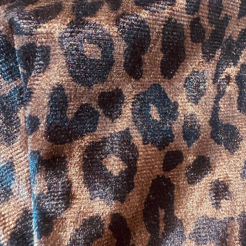 Close-up of leopard print fabric with brown, black, and blue colors.